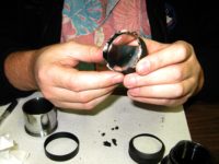 Close-up of badly damaged eyepiece lens & pieces. We did our best and made it serviceable.
